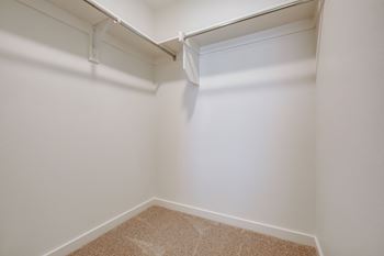 a walk in closet at the oxford at estonia apartments in san antonio,
